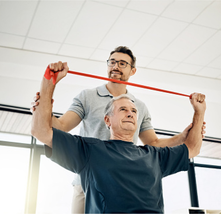 Older man working with a physical therapist. 