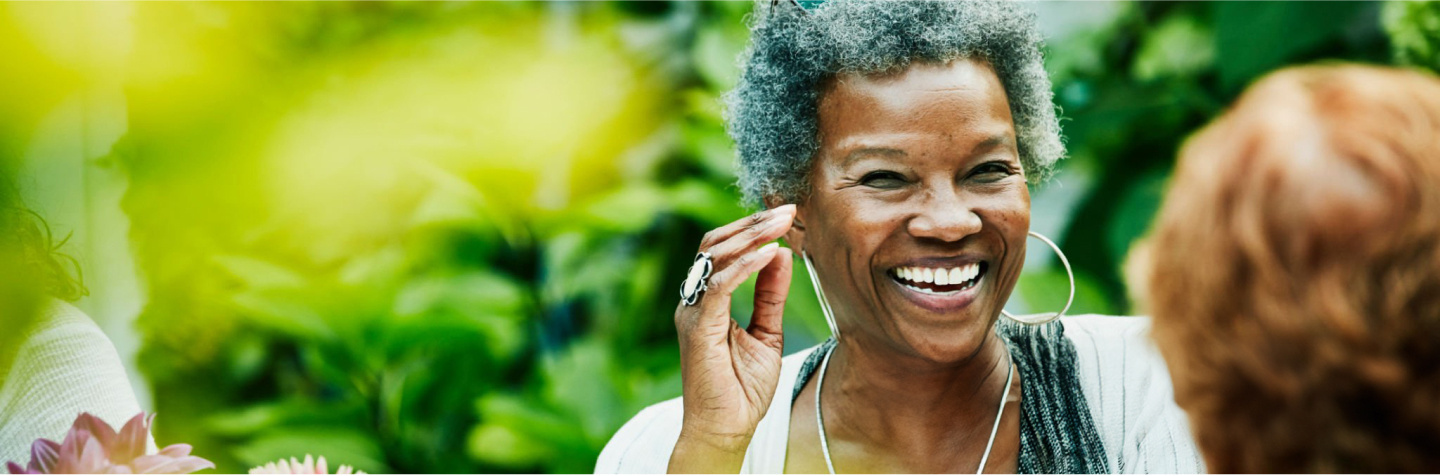 Senior smiling and enjoying a conversation. 